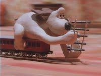 A dog laying down train tracks while riding a train